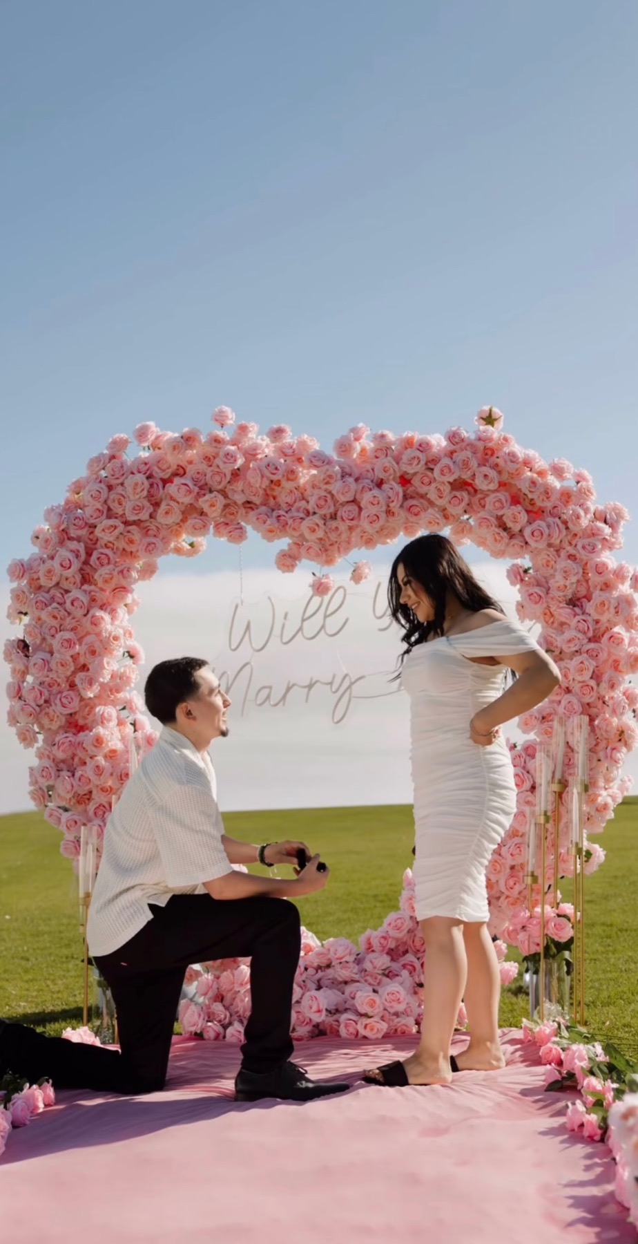Proposal with pink floral heart arch by Big Moments Co.