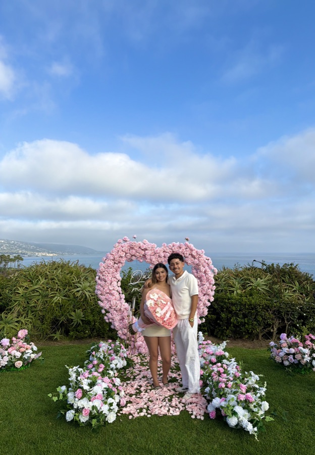 Couple portrait with pink floral heart arch by Big Moments Co.